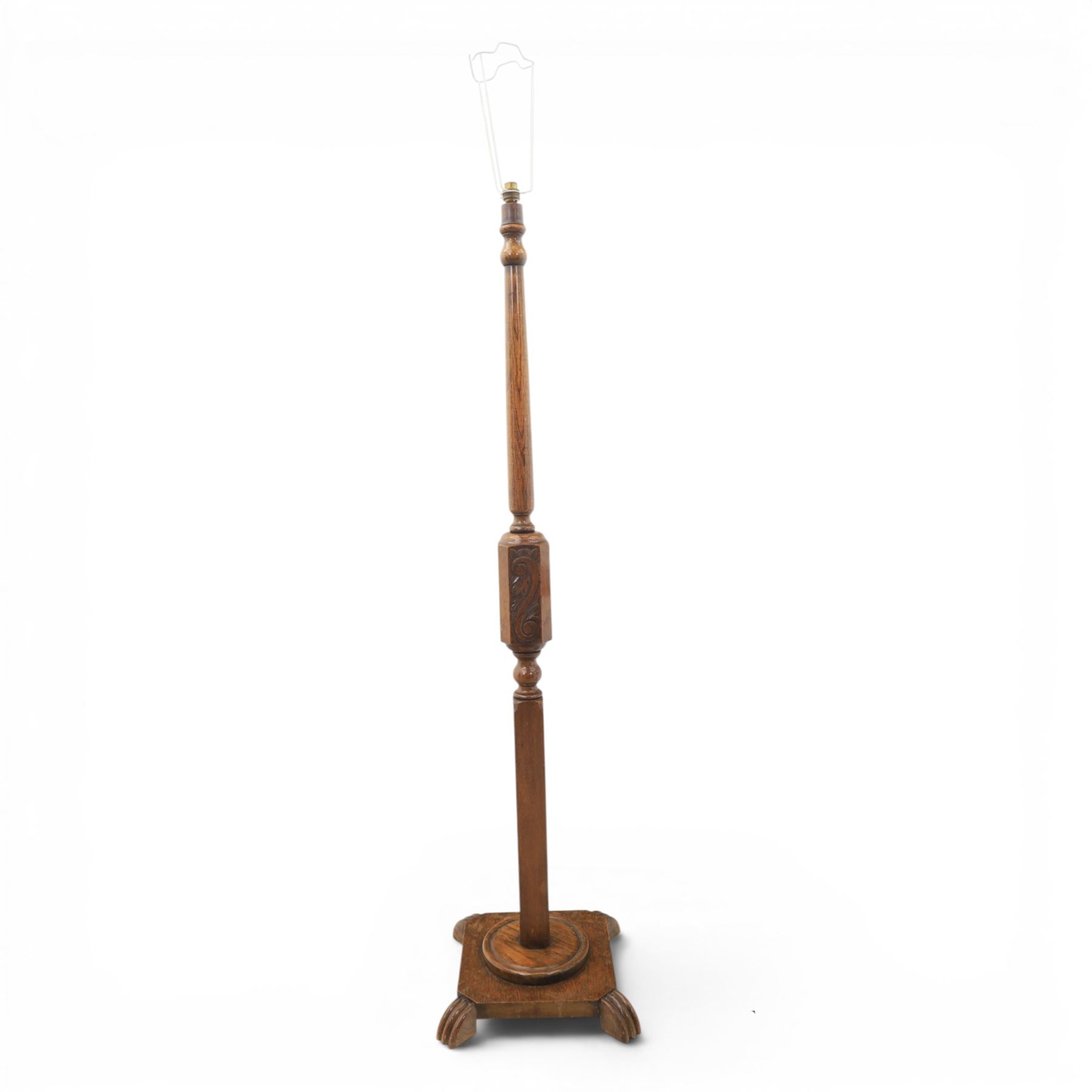 Late Victorian set of two oak standard lamps, turned and carved column supports, one with foliate carved panelled stem, on stepped square bases with carved scroll feet, the other on circular moulded spreading base
