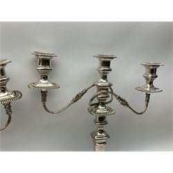 Pair of silver plated three branch candelabra, with urn shaped nozzles on reeded scrolling branches, on a knopped and tapering stem, raised on a regular foot, together with a trefoil wine holder with vine leaf and grape detail, and other silver plate and metal ware, candelabra H47.5cm 