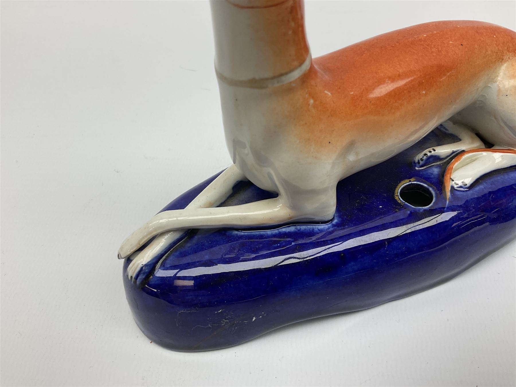 Pair of Staffordshire recumbent greyhound pen holders 