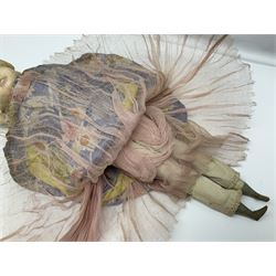 Victorian large wax over composition Pumpkin head doll, with inset dark glass eyes, moulded blonde hair in curls, stuffed body with carved and painted wooden limbs, grey painted boots, floral satin dress with netting underclothes H61cm