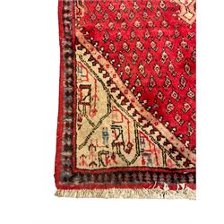 Small Persian red ground rug, lozenge medallion surrounded by small Boteh motifs