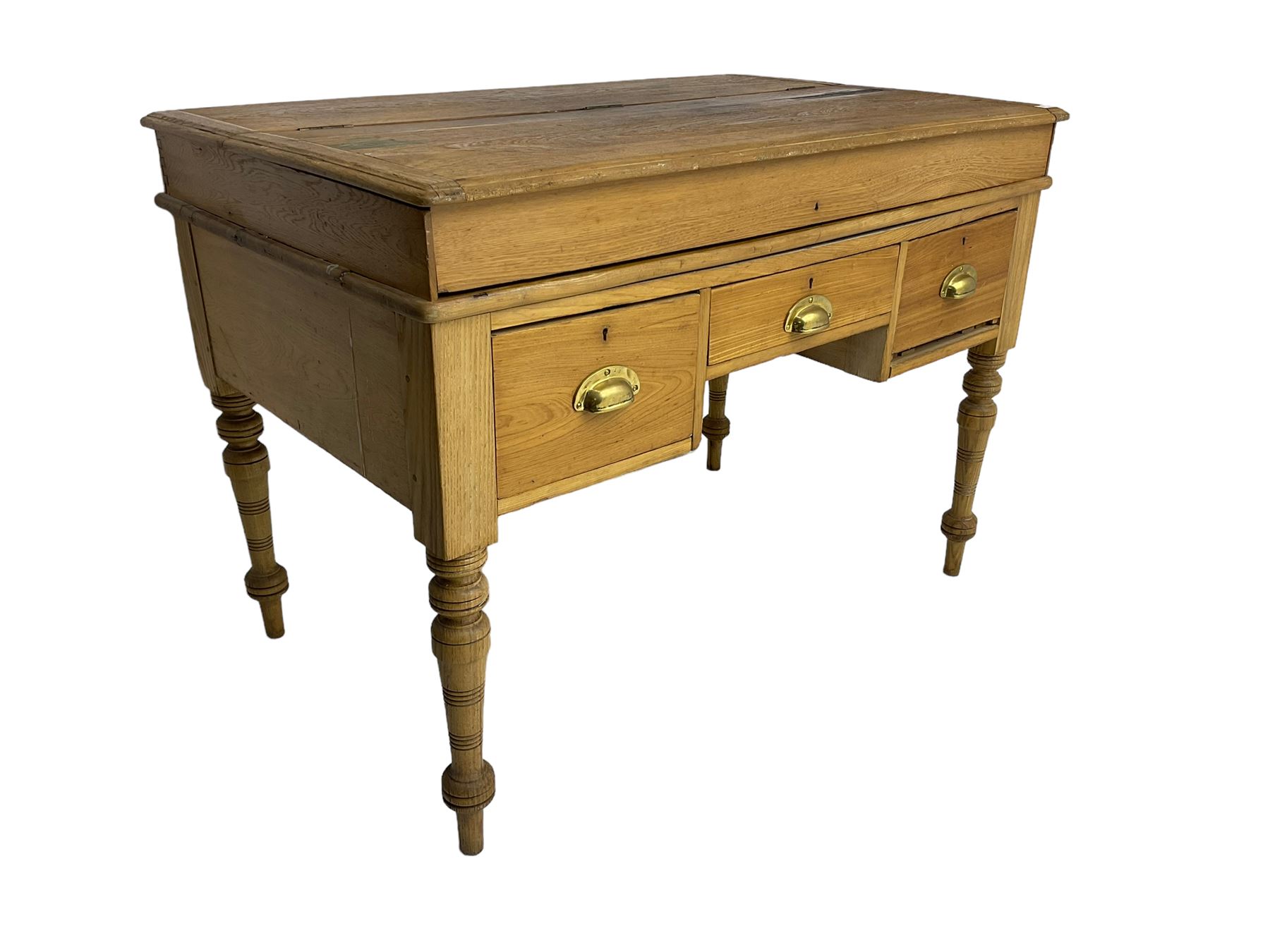 Early 20th century light oak kneehole desk, rectangular hinged top, fitted with frieze drawer flanked by two deep drawers, raised on ring turned supports