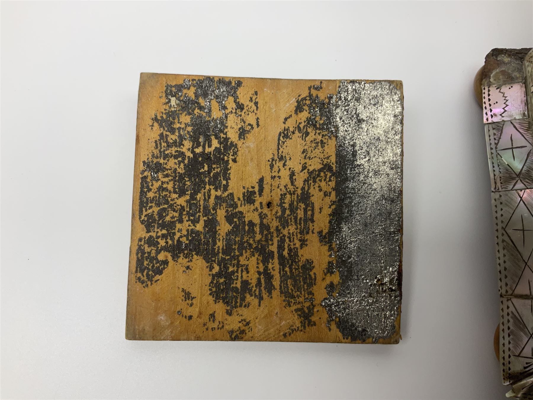 Victorian mother of pearl tea caddy, of rectangular bow-fronted form, the body with floral, bird and geometric engraved mother of pearl panels, white metal shield plaque to the cover inscribed with the initials G.J.A and similar escutcheon, the two division interior with ivory edging and two panelled mother of pearl lids, on four vegetable ivory bun feet L20cm, together with a similar style mother of pearl card case (2) This item has been registered for sale under Section 10 of the APHA Ivory Act