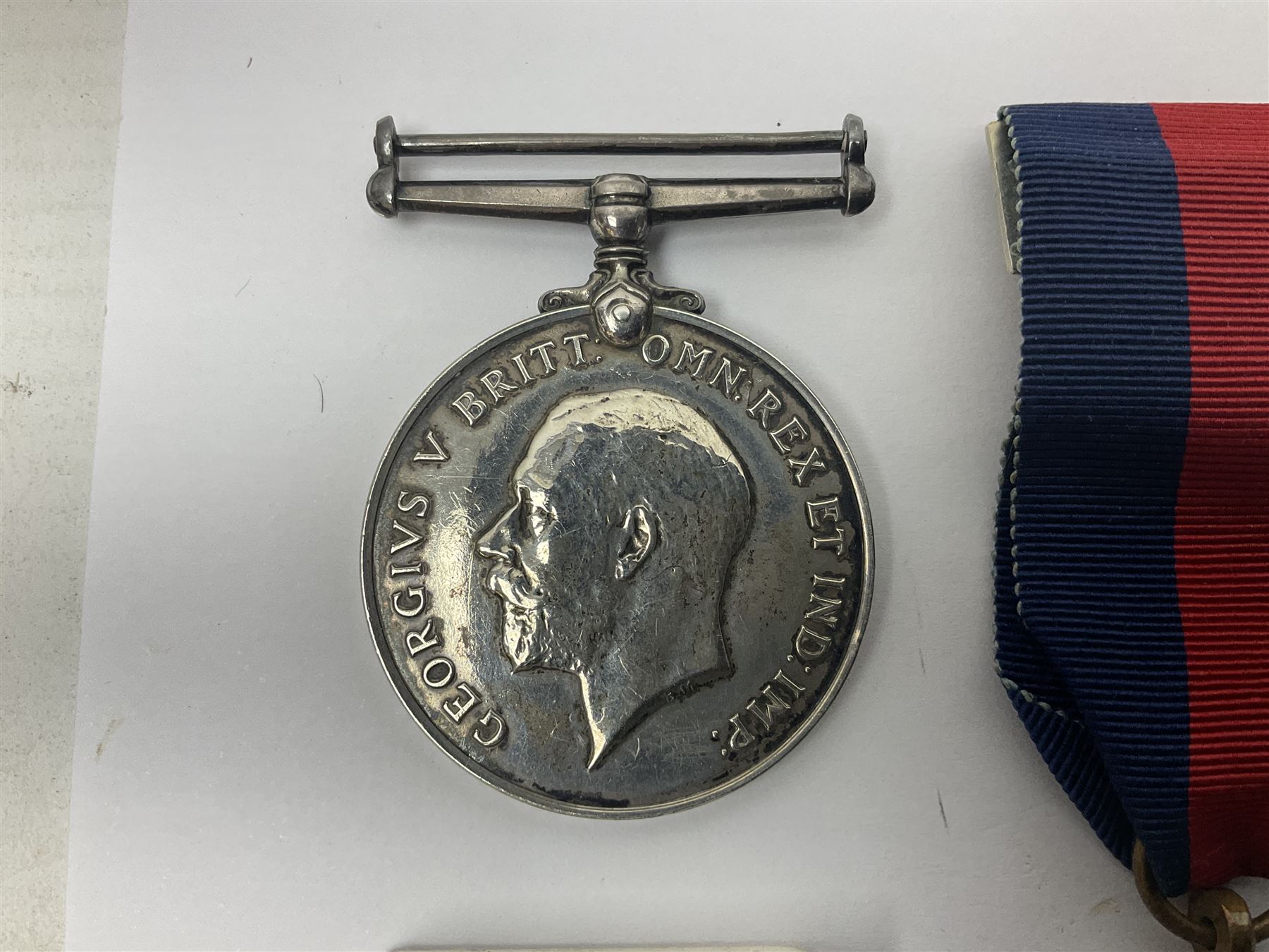 WWII group of five medals comprising 1939-45 War Medal, Defence Medal, 1939-45 Star, Africa Star and France and Germany Star on wearing bar; WWI British War Medal awarded to 142019 Pte. A. Thompson A.S.C.; and boxed King's Badge 'For Loyal Service'