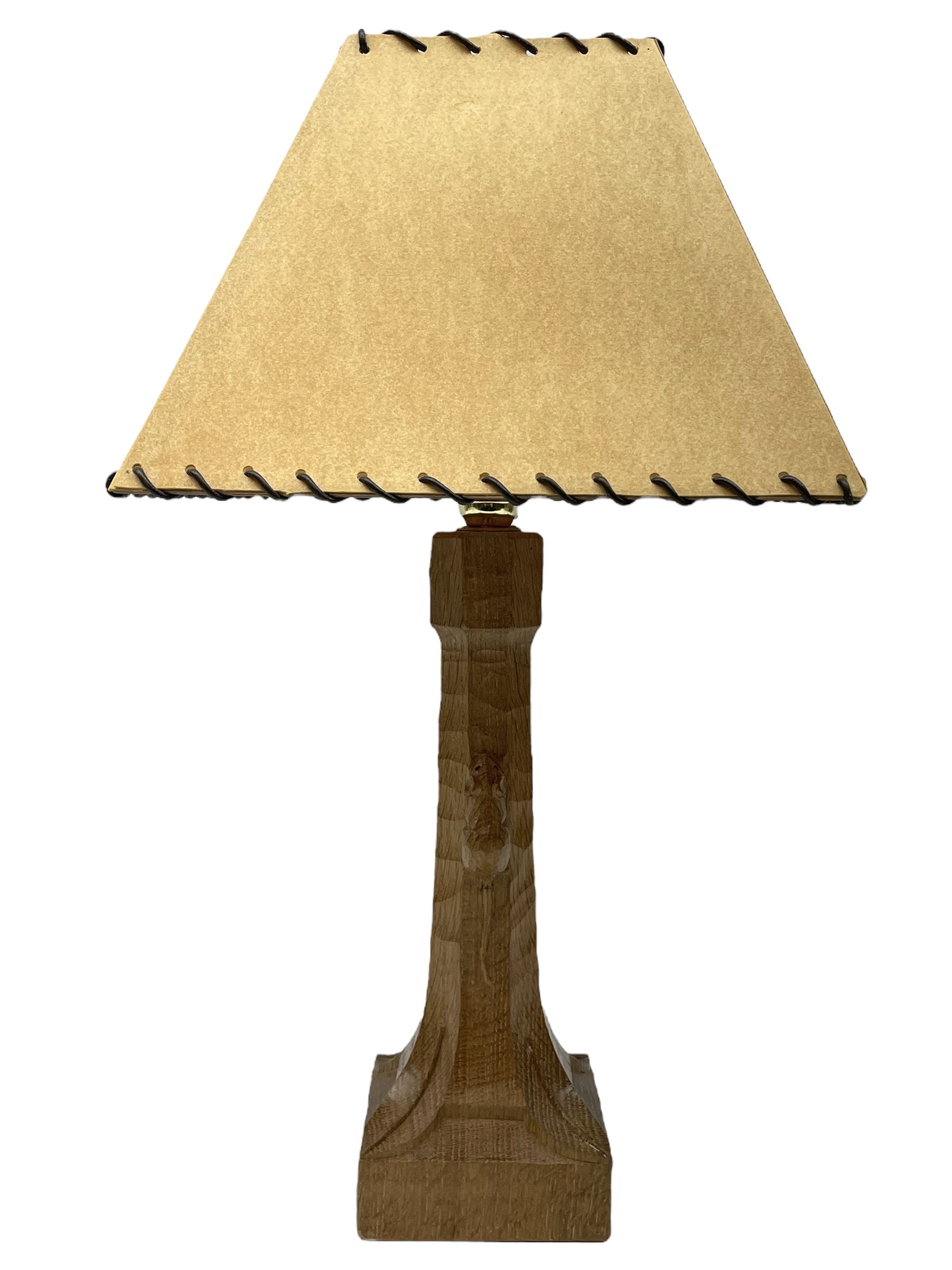 'Mouseman' tooled oak table lamp, the octagonal tapered stem carved with mouse signature, with shade, by Robert Thompson of Kilburn