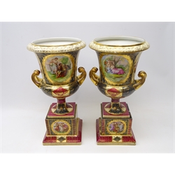  Pair of late 19th Century Vienna style porcelain campana urn shaped vase on stands, decorated with 18th century style panels after Angelica Kauffman, H40cm (one A/F)  