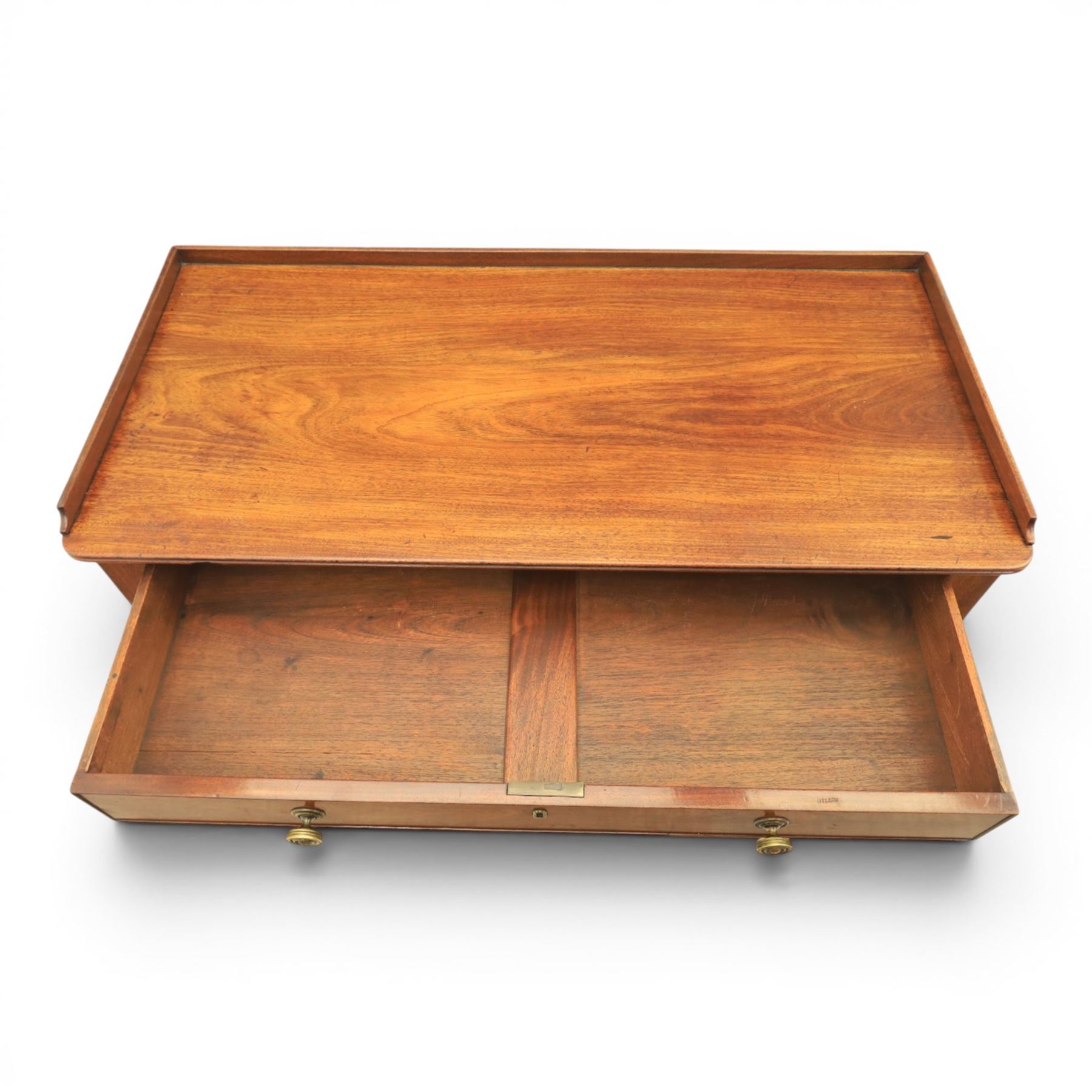 Early 19th century mahogany dressing table, rectangular top with three quarter gallery, frieze drawer with two brass knobs, stamped 'Gillow', raised on turned and reeded supports 