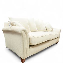 Parker Knoll - contemporary beige upholstered two seat sofa, with flared scroll arms and loose back and seat cushions, standing on stained tapered block feet