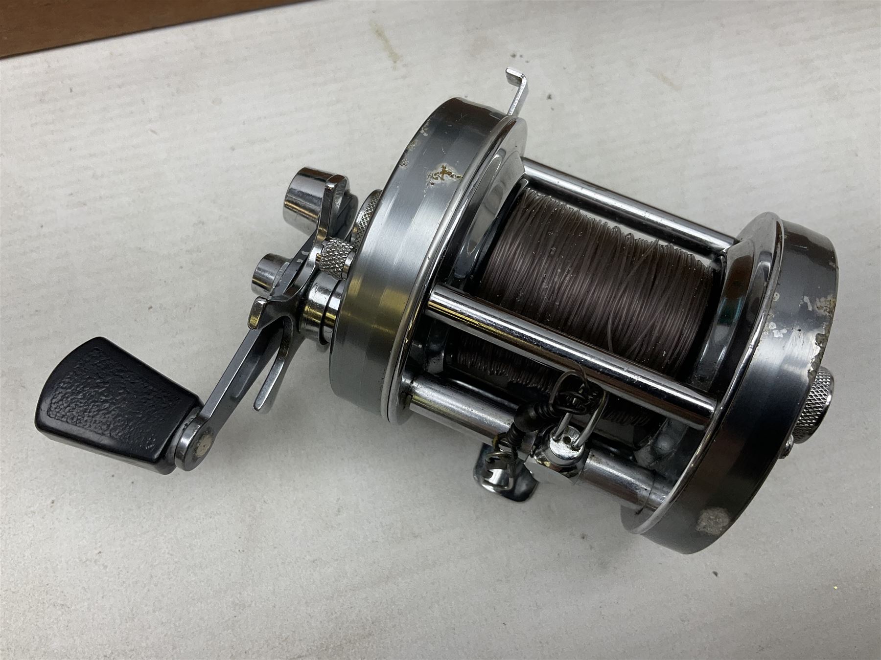 Four Abu fishing reels, comprising Ambassadeur 9000, Ambassadeur 7000, Ambassadeur 5500 and Ambassadeur 6500, together with additional line, hardy fishing bag and two wooden boxes