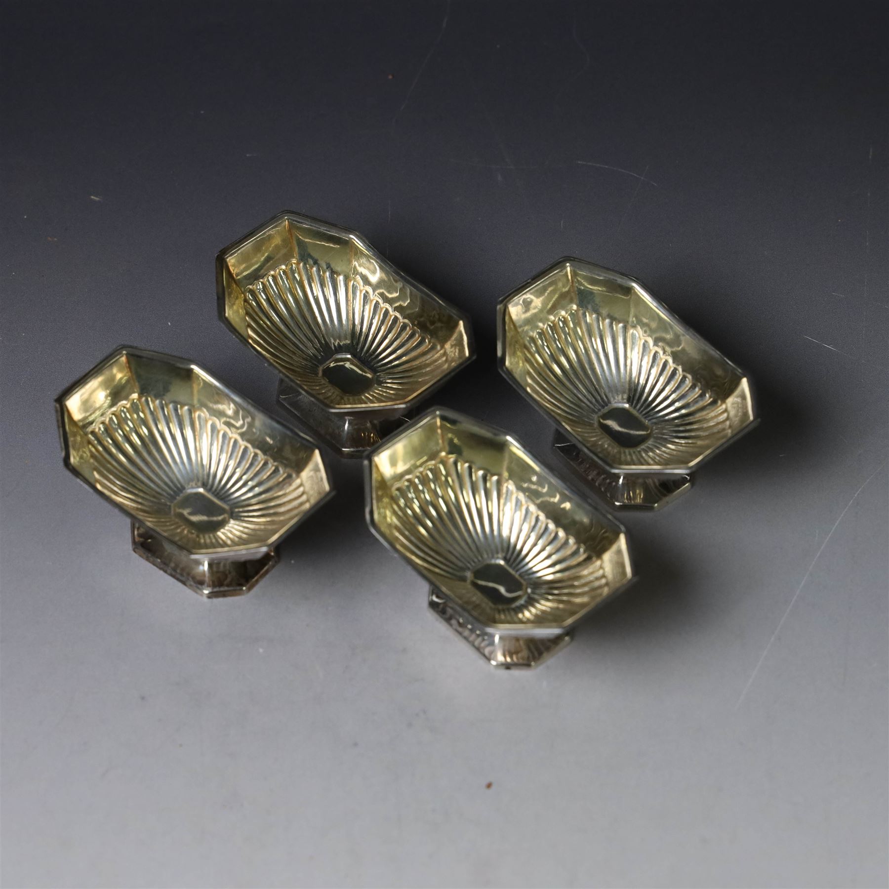 Set of four late Victorian silver open salts, of octagonal part fluted form, with four clam shell spoons, hallmarked Colen Hewer Cheshire, Birmingham 1896, salts H4cm, contained within fitted case