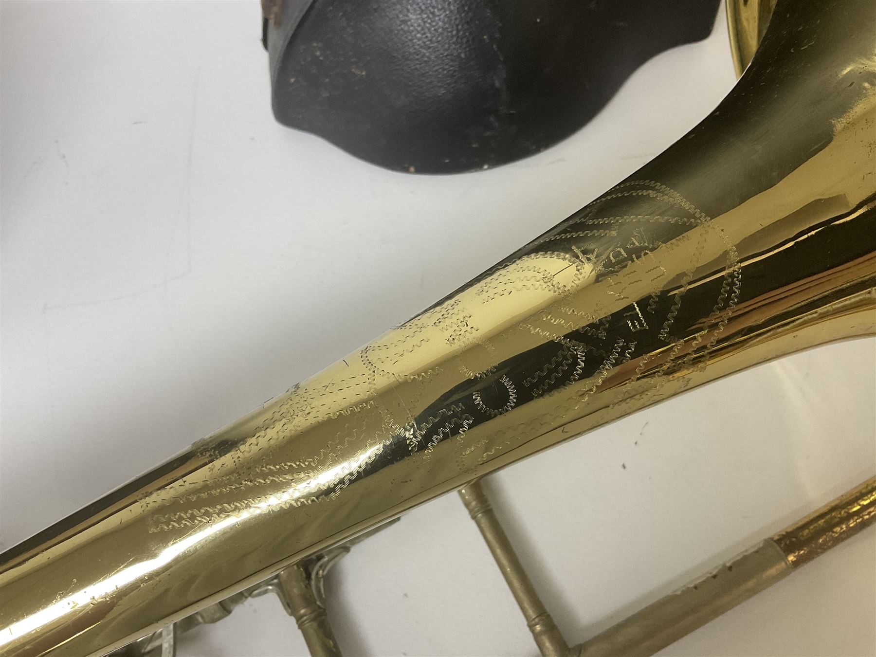 Three brass trombones comprising Elkhart Ind. USA 'CONN' model no.72H; Besson 'Concord'; and Selmer Distributed 'Lincoln'; two in carrying cases; and German B & M 'Champion' brass trumpet (4)