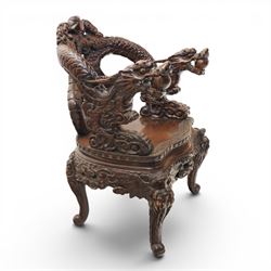 Chinese carved hardwood dragon throne chair, the shaped and pierced back with entwined dragons and cloud motifs, sweeping dragon-form arms terminating in carved heads, solid panel seat over foliate carved apron, on four mask carved cabriole supports