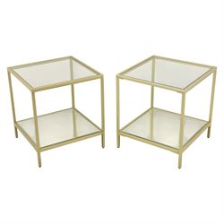 Modern pair of brass finish and glass bedside stands, each of square form with clear glass...