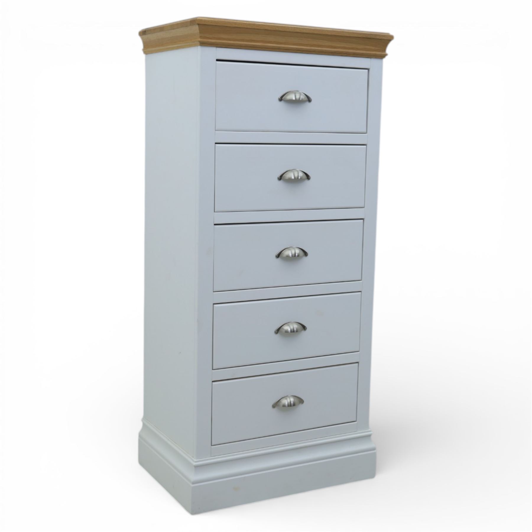 Modern narrow chest of five drawers in white finish with oak moulded top, with metal cup handles raised on a moulded plinth base