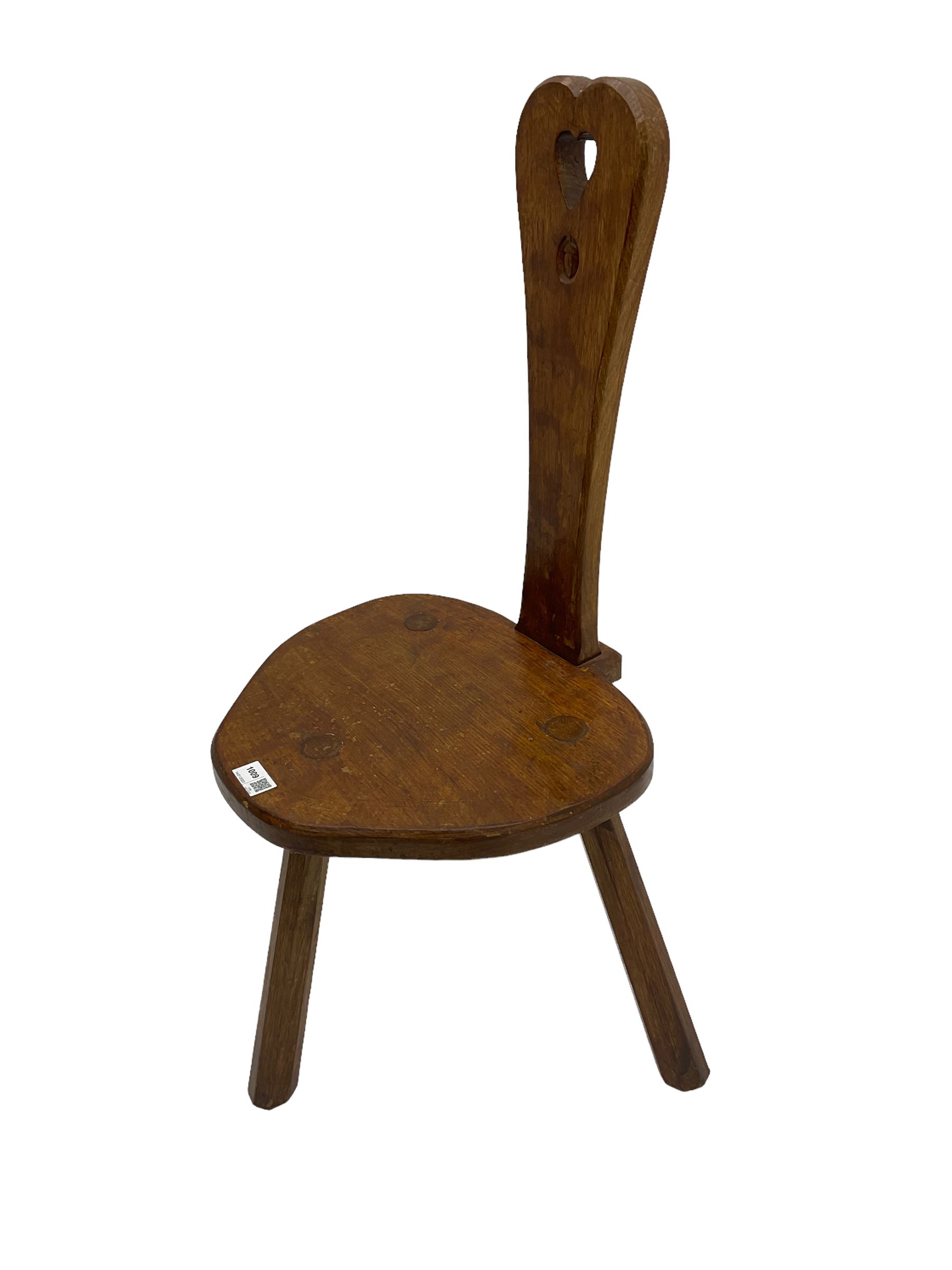 Acornman - adzed oak spinning chair, spoon shaped back with pierced heart and acorn signature, spade-shaped seat raised on octagonal tapering supports by Alan Grainger of Brandsby