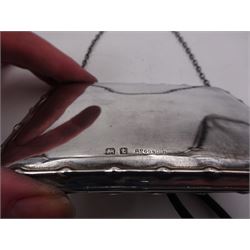 Early 20th century silver purse, of rectangular form with beaded border and finger chain, opening to reveal a leatherette interior with plastic aide memoir, hallmarked Birmingham 1918, maker's mark worn and indistinct, L10cm