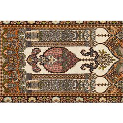 Indian silk-inlaid prayer rug, ivory field decorated with a triple-arched Mirab motif, pendant medallion, paired birds and flowering vases, enclosed by a black ground guard band of scrolling foliage and palmettes