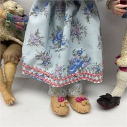 Anna Meszaros Hungary - five hand made needlework figurines including goose girl with stick H20cm; shepherdess in a sitting pose playing a penny whistle with a lamb on her knee; young girl holding a flowerpot; and two others (5)  Auctioneer's Note: Anna Meszaros came to England from her native Hungary in 1959 to marry an English businessman she met while demonstrating her art at the 1958 Brussels Exhibition. Shortly before she left for England she was awarded the title of Folk Artist Master by the Hungarian Government. Anna was a gifted painter of mainly portraits and sculptress before starting to make her figurines which are completely hand made and unique, each with a character and expression of its own. The hands, feet and face are sculptured by layering the material and pulling the features into place with needle and thread. She died in Hull in 1998.