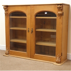  Victorian pine bookcase display cabinet, two arched doors enclosing three shelves, W128cm, H107cm, D41cm  
