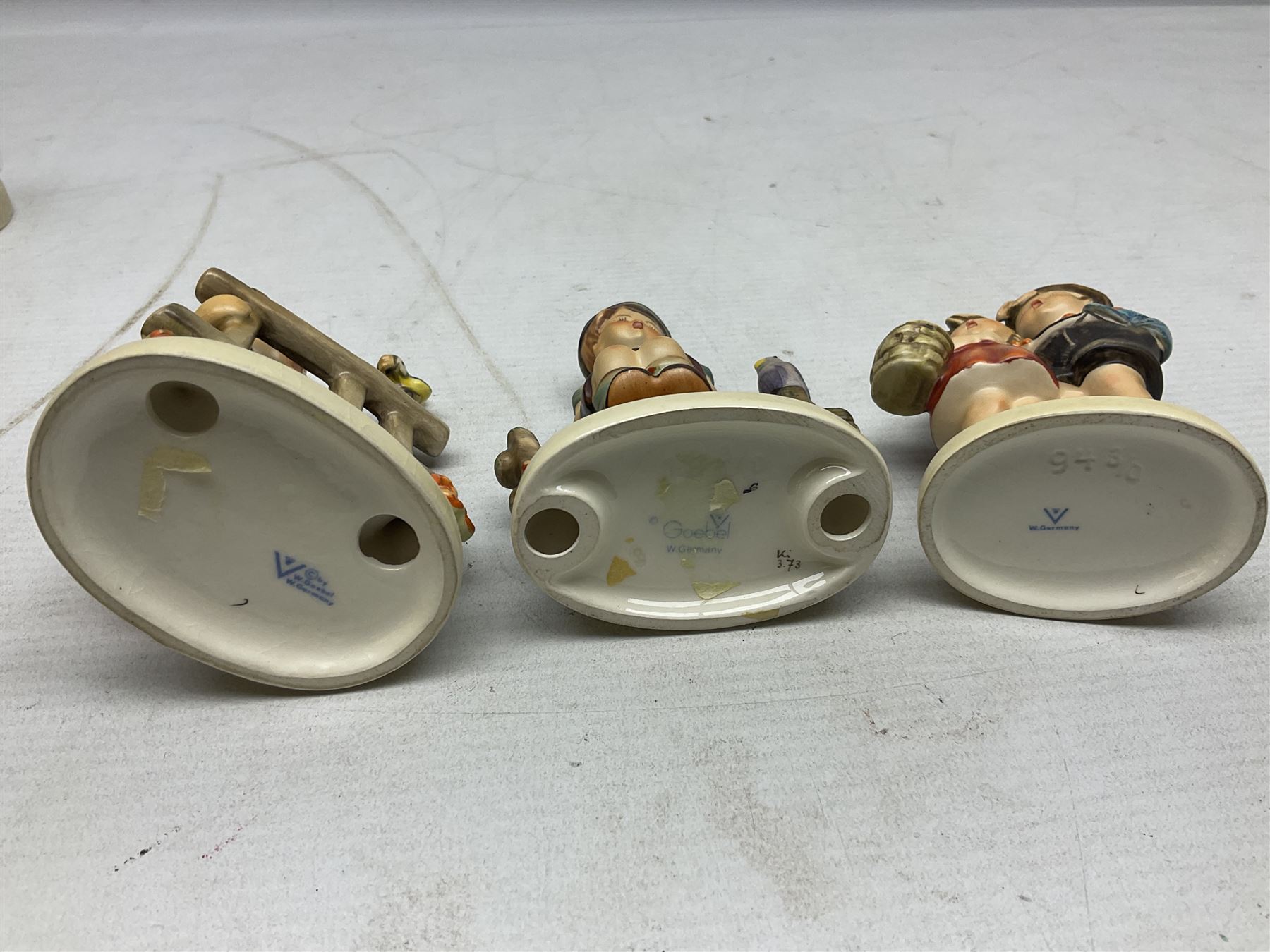 Seven Goebel Hummel figures, comprising Chimney Sweep 12/I, Apple Tree Girl 14/I, Apple Tree Boy,  Little Goat Herder 200/I, Surprise 94 3/0, Signs of Spring 203/20 and Wayside Harmony 111/30, tallest H15cm