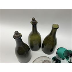 A group of 19th century glassware, comprising three green bottle glass bottles of mallet form, a pair of green glass ewers, three green glass wine glasses, and a clear glass fly catcher. 