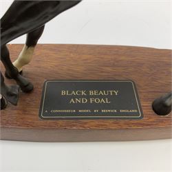 A Beswick figure modelled as Black Beauty and Foal, matt glaze, upon oval wooden base, overall H19cm L29.5cm. 