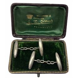 Pair of early 20th century silver bullet cufflinks hallmarked for Birmingham, in leather case with green velvet and silk interior. 