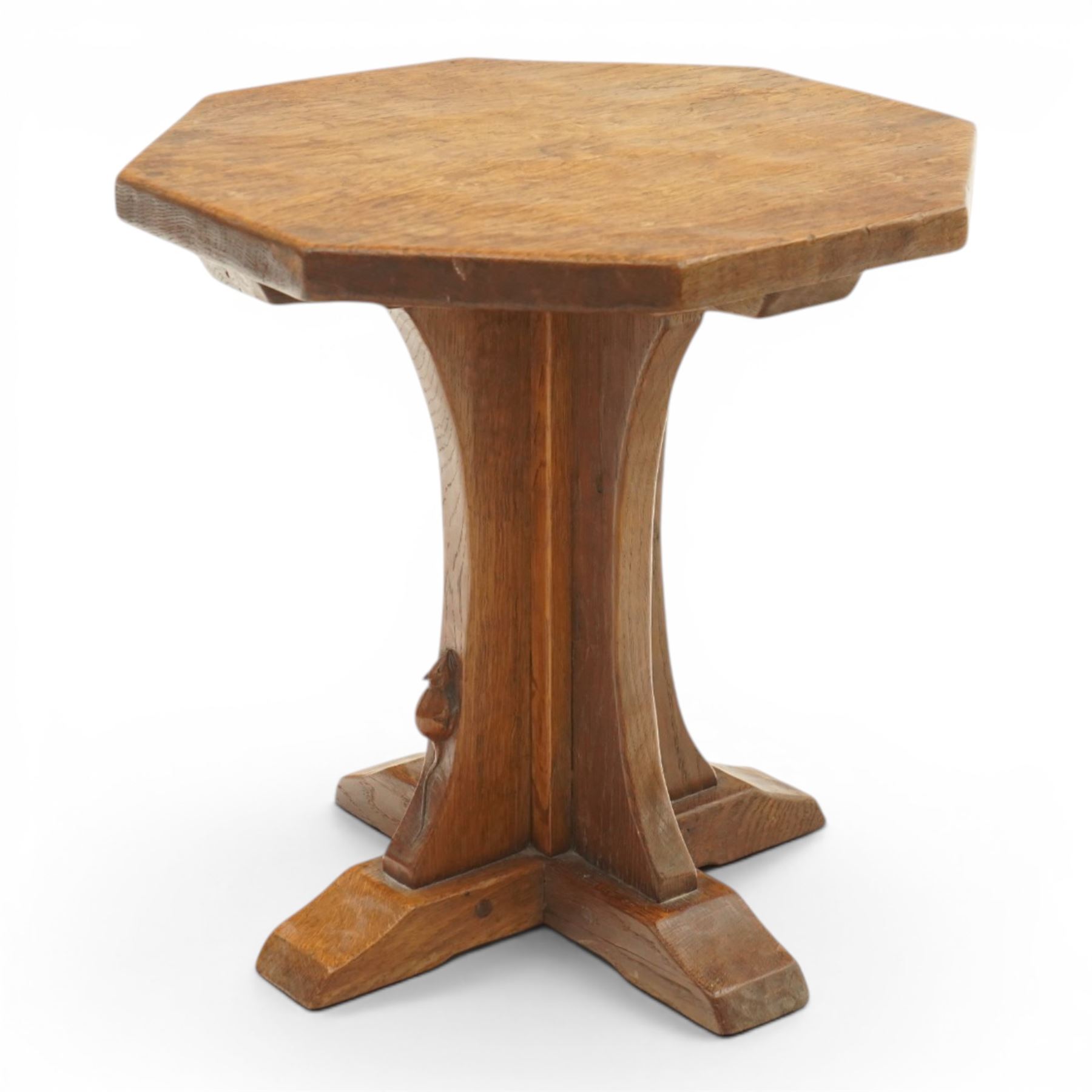Mouseman - mid-20th century adzed oak coffee table of small proportions, the octagonal  adzed top raised on cruciform base and sledge feet, carved with mouse signature, by the workshop of Robert Thompson of Kilburn 