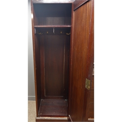  Art Nouveau mahogany triple wardrobe, projecting cornice above two full length bevel edged mirror glazed doors, interior with hanging rails and hooks, central cupboard with bullseye glazed doors, three drawers, on shaped plinth base, W221cm, H206cm, D61cm  
