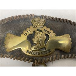 Victorian Queen Victoria record reign horse brass and H&SNCC Parade Badge of Merit 1911 horse brass, both on leather strap, together with 1924 British Empire Exhibition brass Lipton's souvenir tea caddy, strap L36cm