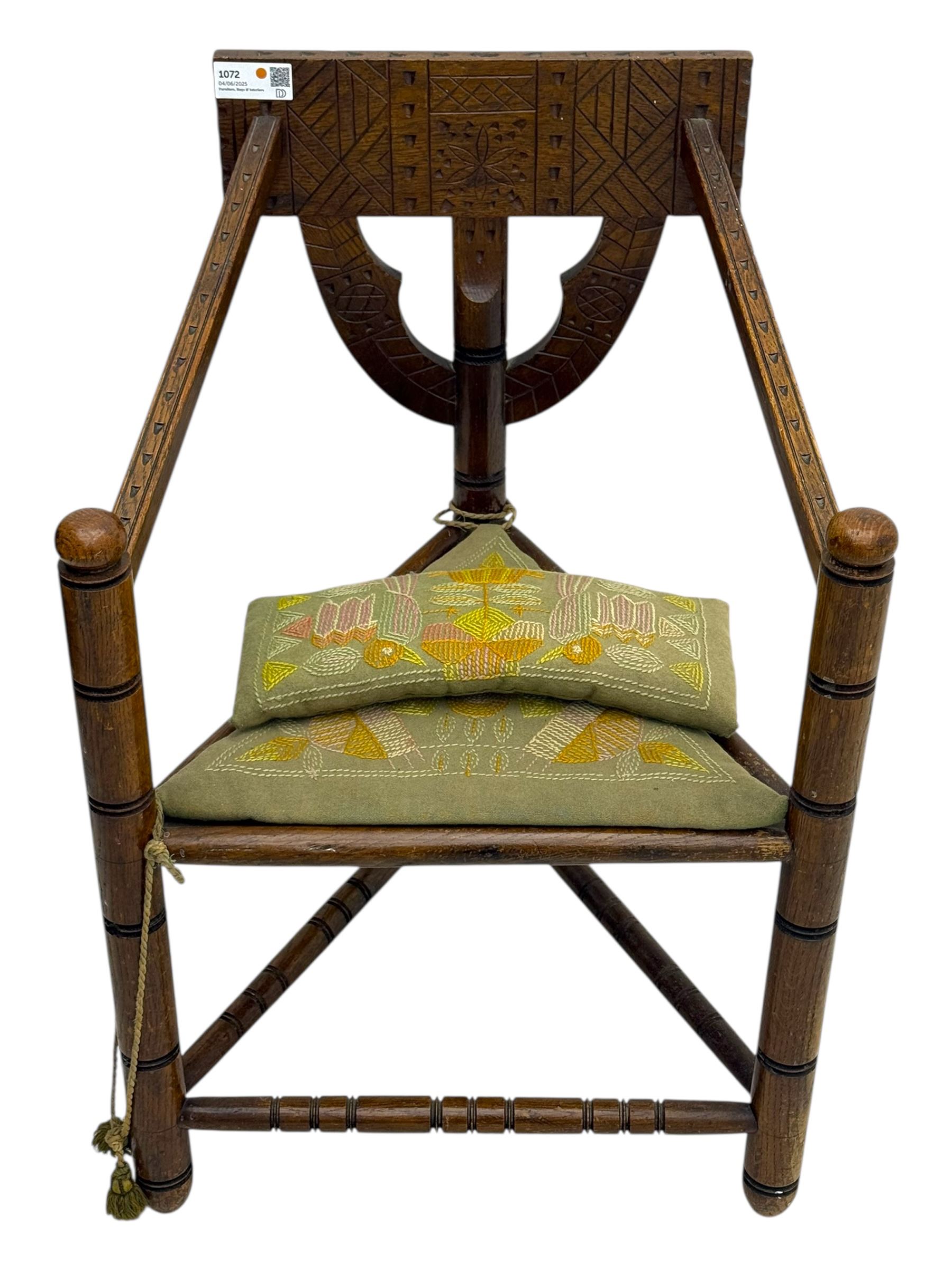 19th century swedish monk's chair, the oak frame with triangular seat and sloped arms, the backrest carved with geometric chipwork and a central pierced medallion 