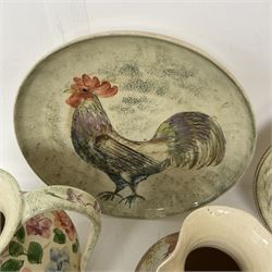 Collection of Yorkshire Moorlands Pottery, comprising two large circular dishes and three jugs, decorated with various fish, flowers, red grouse and cockerel
