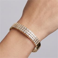 14ct gold diamond hinged bangle, fifteen rows each channel set with three round brilliant cut diamonds, stamped 14K, total diamond weight approx 3.15 carat