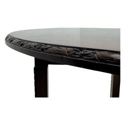 Early 20th century mahogany demi-lune table, the circular top with carved foliate border, raised on square section supports with relief carved edges