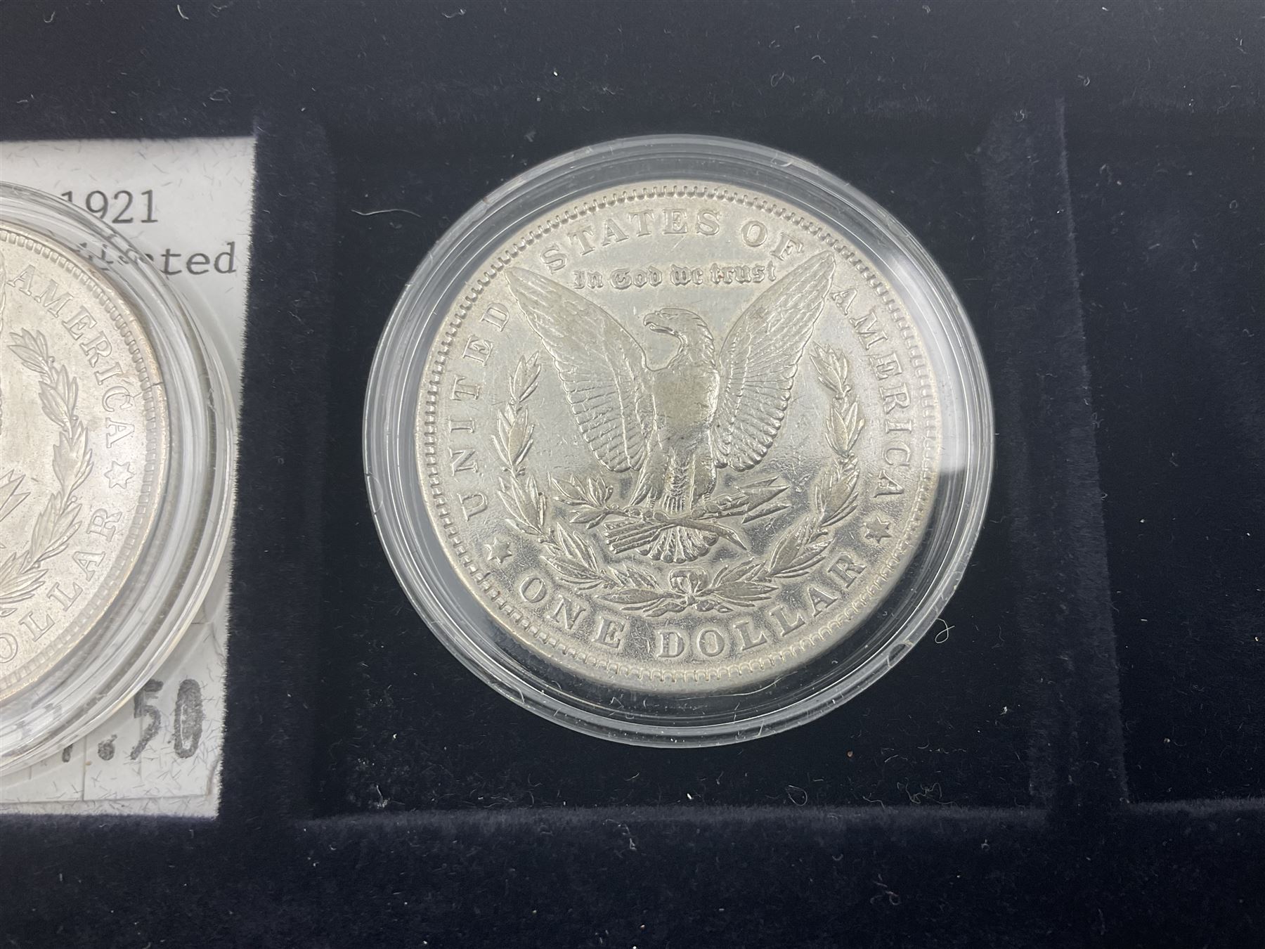 Seven United States of America silver Morgan dollar coins, dated 1884, 1901 O, 1902 O, 1903, 1904 O, 1921 D and 1921