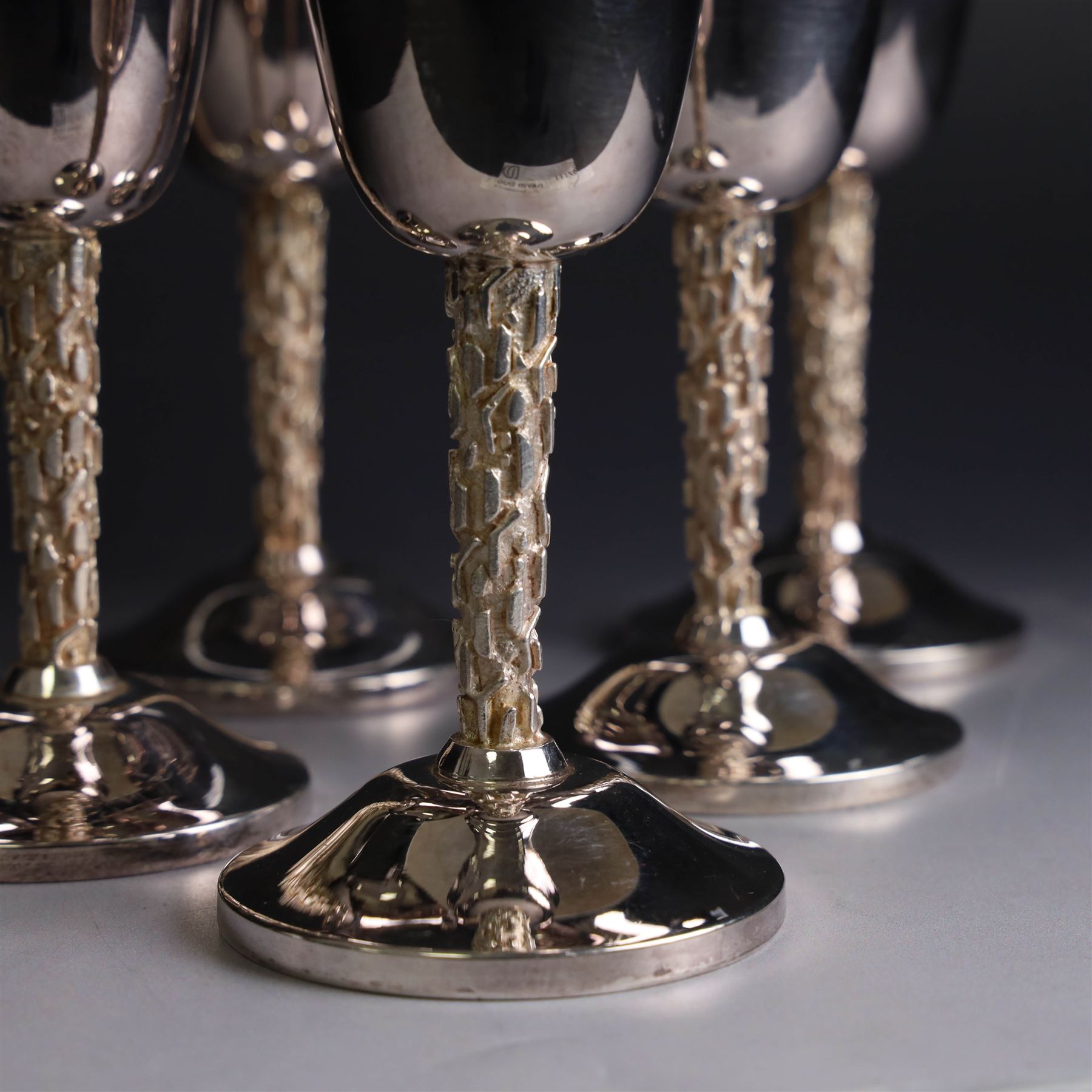 Eight silver goblets, comprising set of six, each plain fluted bowl with gilt interior, upon bark effect stem and domed circular foot, and a pair of very similar examples boxed with large hallmarks to bowls, hallmarked Pinder Brothers, Sheffield 1970 and Sheffield 1976, H14cm