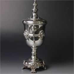 Mid 20th century silver twin handled trophy cup and cover, the bowl with central mask mounted girdle upon a knopped stem and spreading circular foot with flower head mounted paw feet, the tapering stepped cover with leaf moulded knop finial, hallmarked Vaughton & Sons, Birmingham 1938