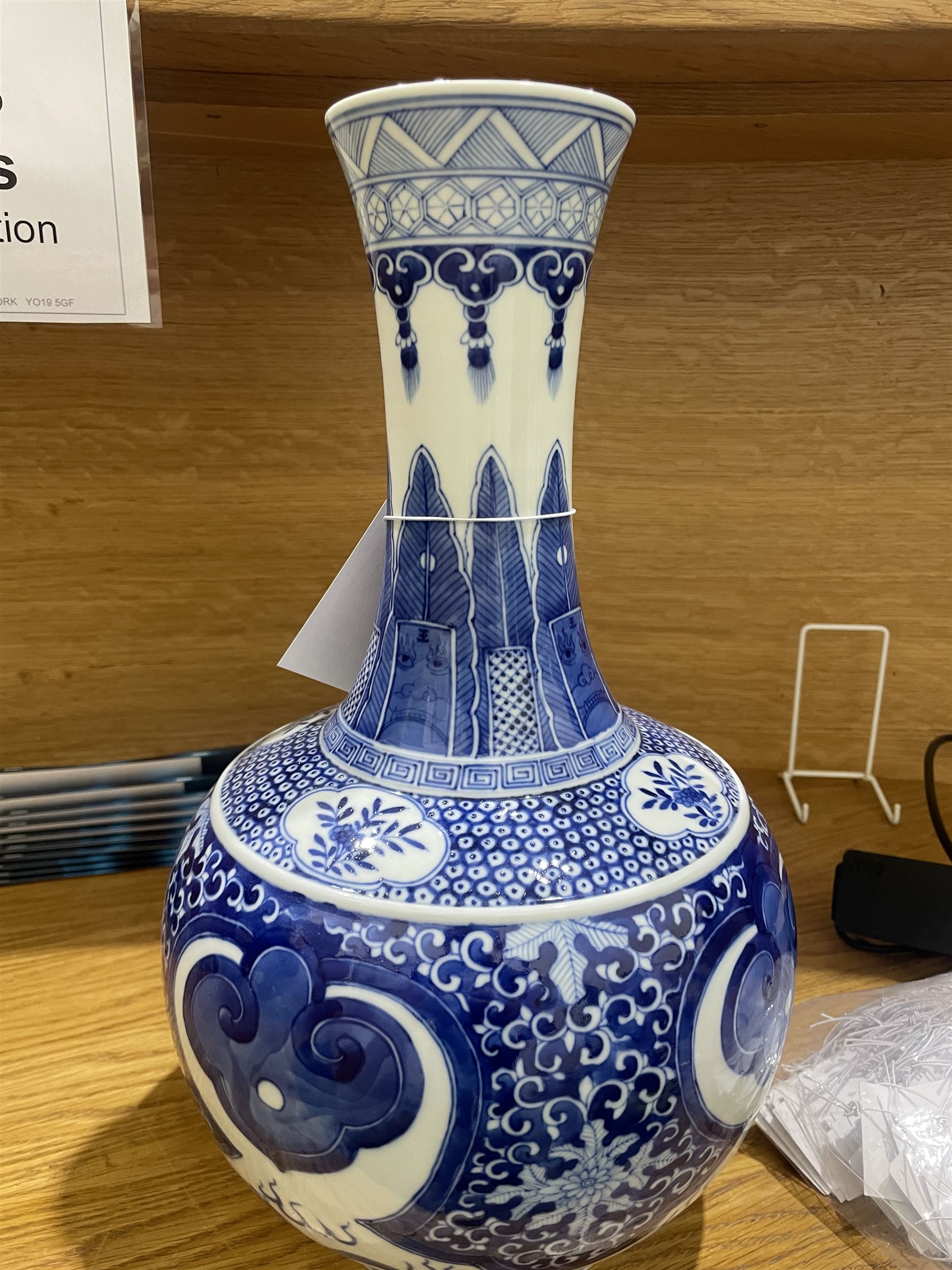 Late Qing Dynasty bottle vase decorated in blue and white with dragons and pearls, stylised leaves and flowers with key pattern foot H40cm 
