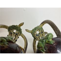 Pair of 19th century Portuguese Palissy style Majolica puzzle jugs, attributed to Manuel Mafra, with mossy rim and pierced lattice neck, twin handles in the form of snakes and the body decorated with frogs, lizards, and moths on a mottled brown glazed ground, unmarked, H20cm