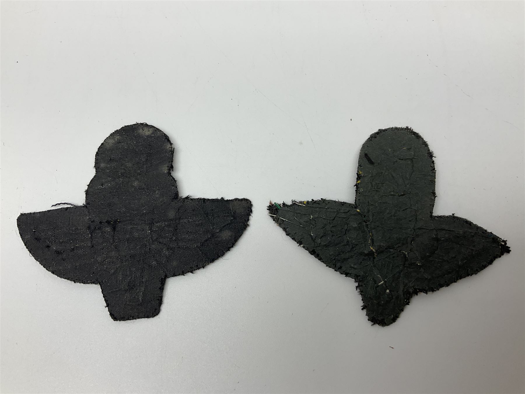 Parachute regiment - chrome crest on oak easel shield; three cloth badges; small silver plated figure; and pin badge; together with 10cm diameter cannon ball etc