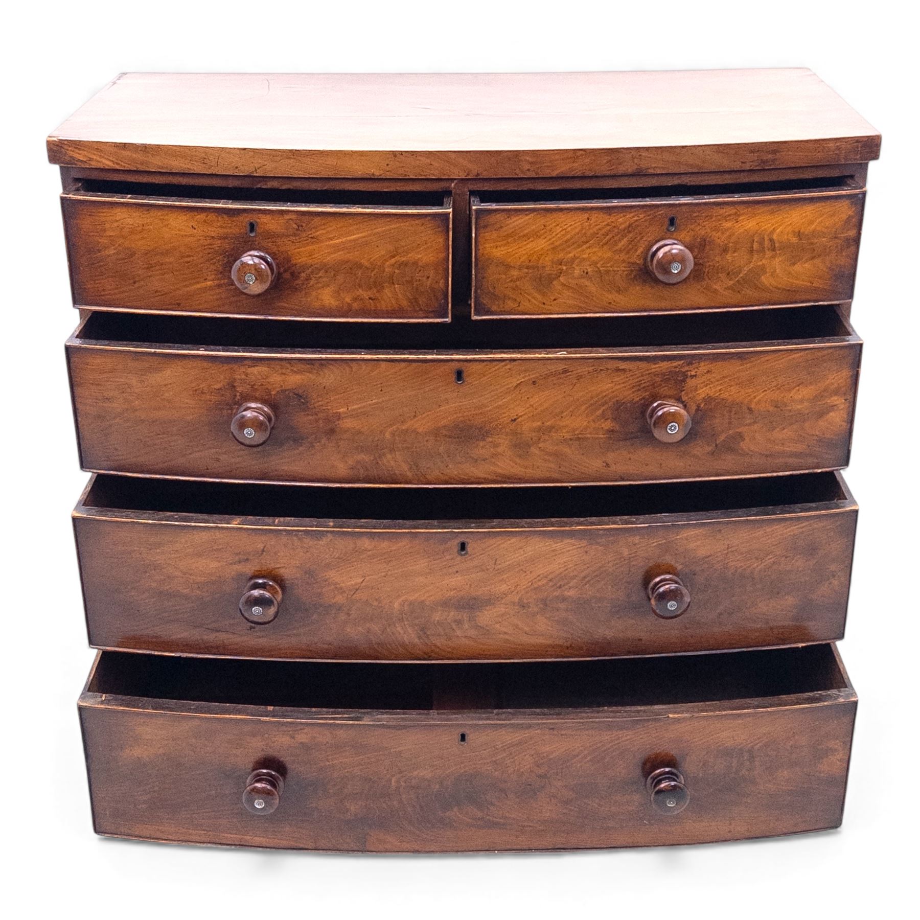 19th century bow front mahogany chest of drawers, rectangular top with moulded edge above an arrangement of two short and three long graduating drawers with turned wooden handles, raised on turned feet