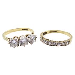Gold three stone cubic zirconia ring and a gold cubic zirconia half eternity ring, both hallmarked 9ct