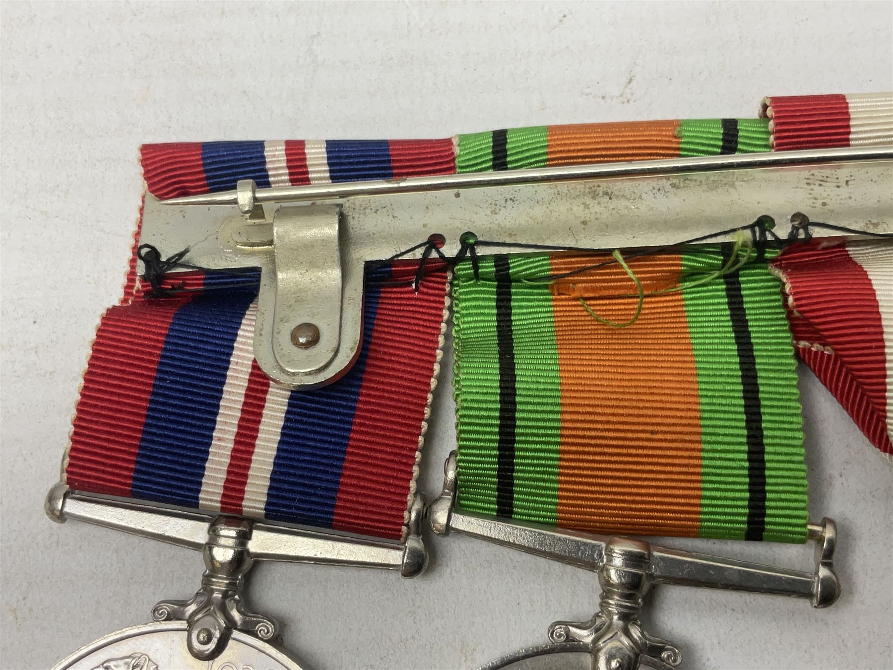 WW2 group of four medals comprising 1939-1945 War Medal, Defence Medal, Italy Star and 1939-1945 Star; with Royal Army Service Corps cap badge and RASC chrome and enamel sweetheart brooch