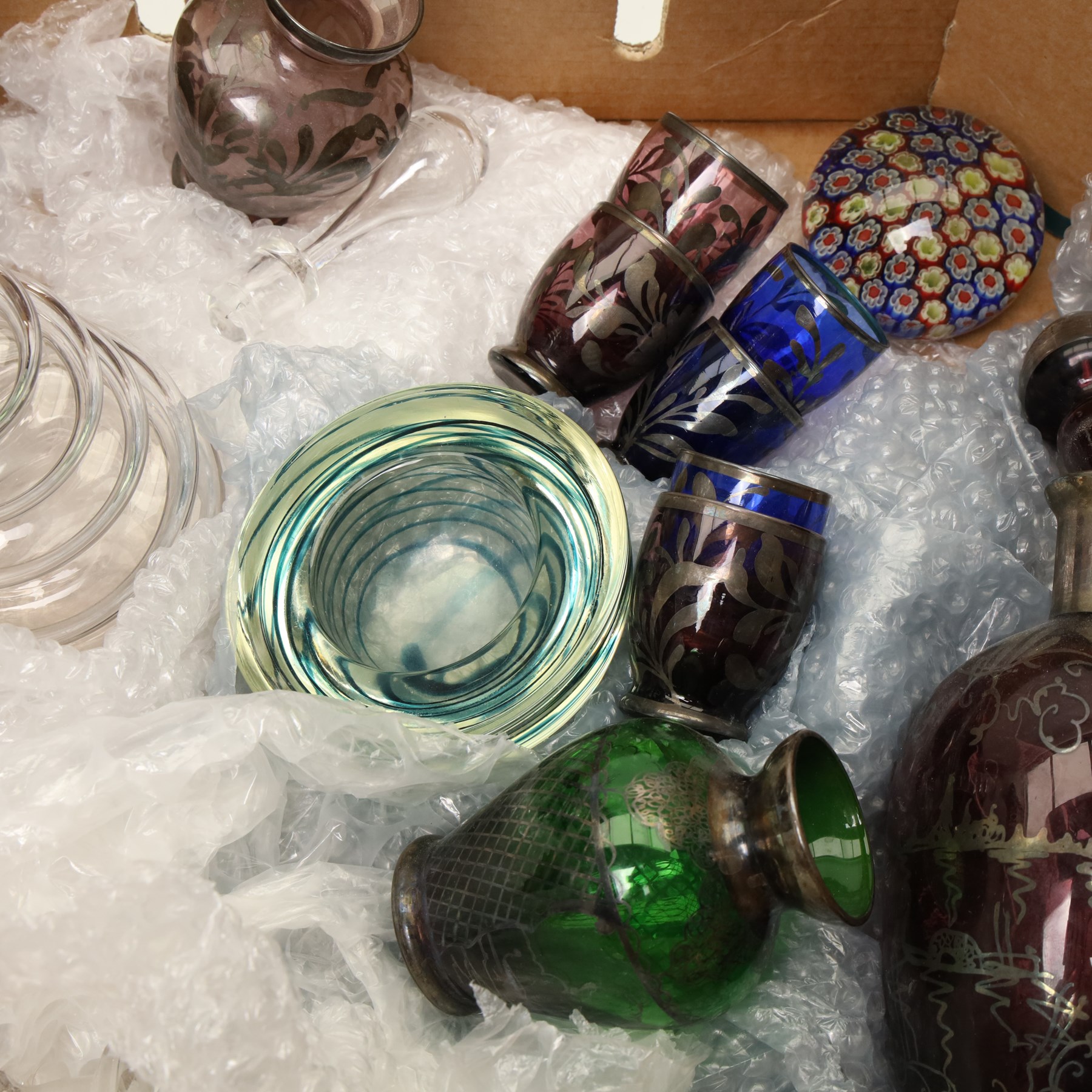 Box of miscellaneous items including coloured glass liqueur decanter and tots, two paperweights, glass carafe etc
