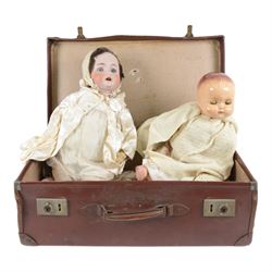 German bisque head doll and a Roddy doll, in suitcase