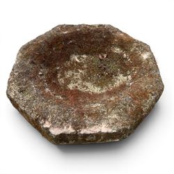 19th century weathered sandstone birdbath, the octagonal canted dished top raised on a ring turned flared pedestal, with four carved stylised dolphins to the squared base