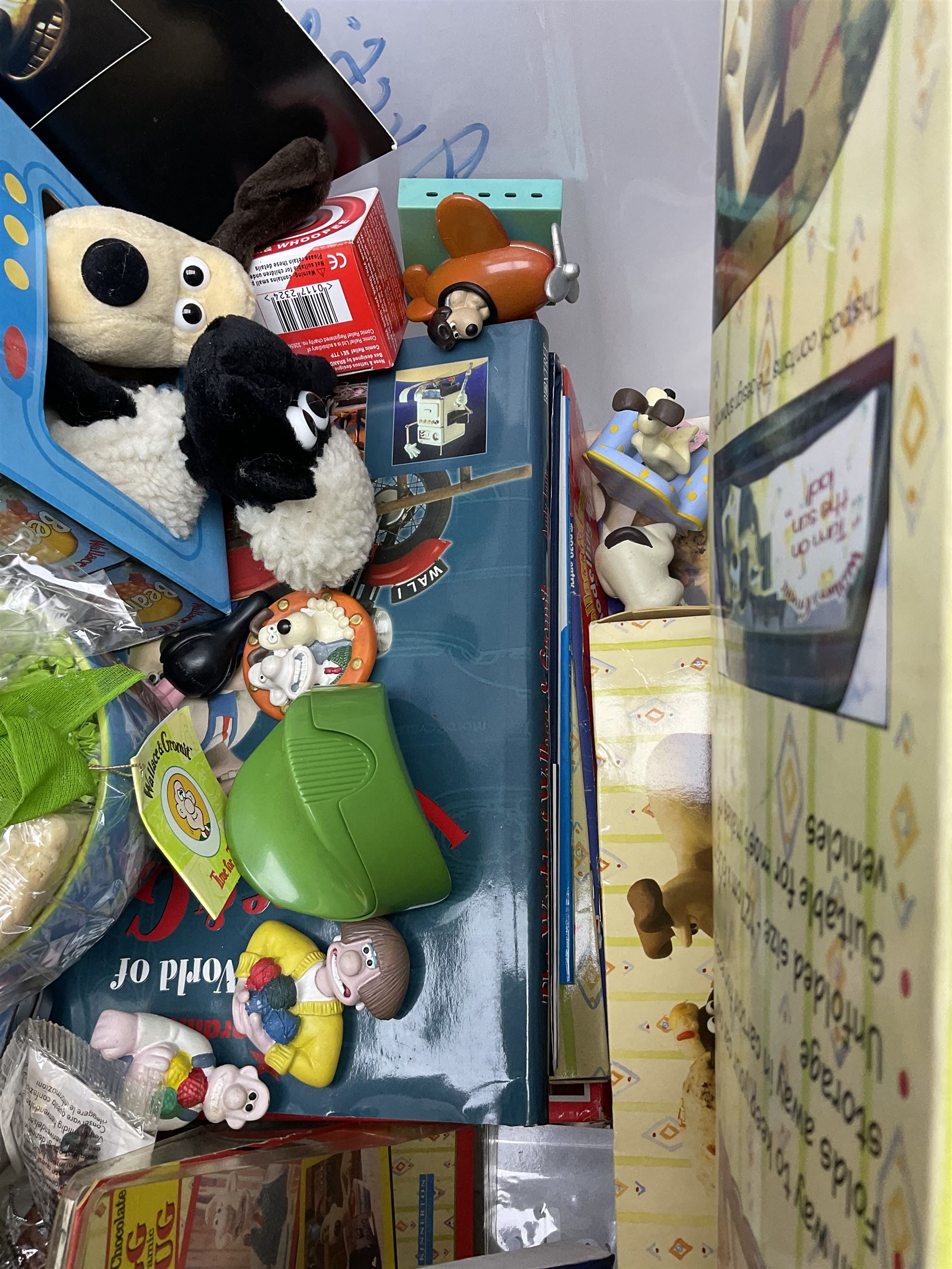 Quantity of Wallace and Gromit toys, accessories and memorabilia including soft toys, figurines, electronic ‘Talking Wallace’, car screen shades, and a quantity of Chicken Run Related merchandise, in three boxes
