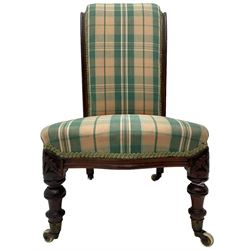 Small Victorian walnut framed nursing chair or doll's chair, upholstered in checkered fabric, turned front supports, brass and ceramic castors