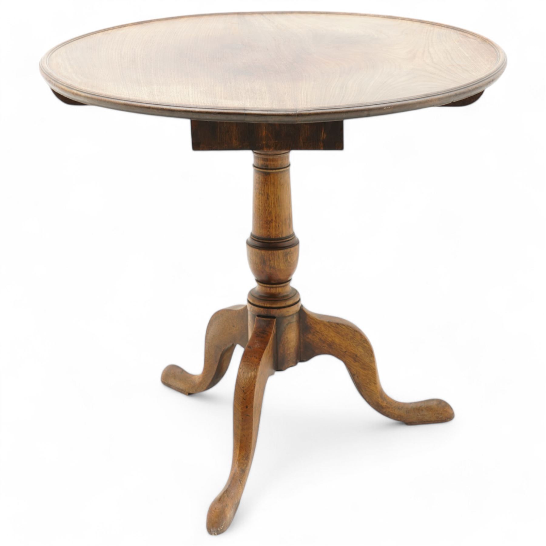 George III mahogany tripod table, circular dished tilt-top with moulded edge on cage action, baluster turned pedestal with three splayed supports 