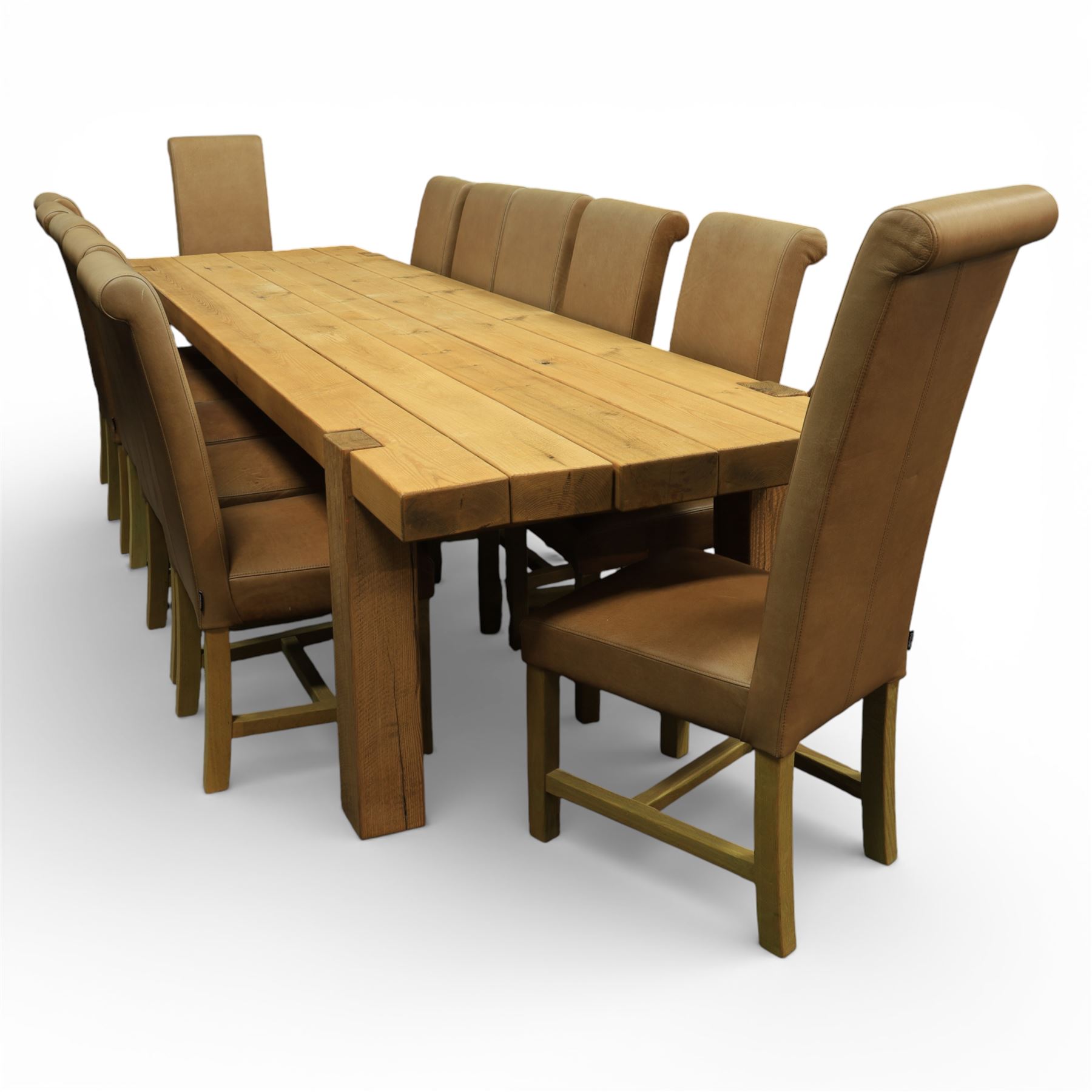 Modern large oak plank top dining table and twelve brown leather high back chairs, table of rustic construction five solid planks with exposed supports, the chairs in brown leather hide with ten standard height and a pair of taller chairs for the foot and head of the table